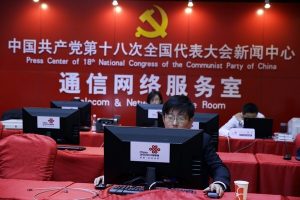 A Chinese man uses a computer at the press center of the 18th Communist Party Congress in Beijing, China, Tuesday, Nov. 13, 2012. During China's last party congress, the cadres in charge of the world's most populous nation didn't know a hashtag from a hyperlink. But five years on, there's a new message from Beijing: The political transition will be microblogged. (AP Photo/Ng Han Guan)